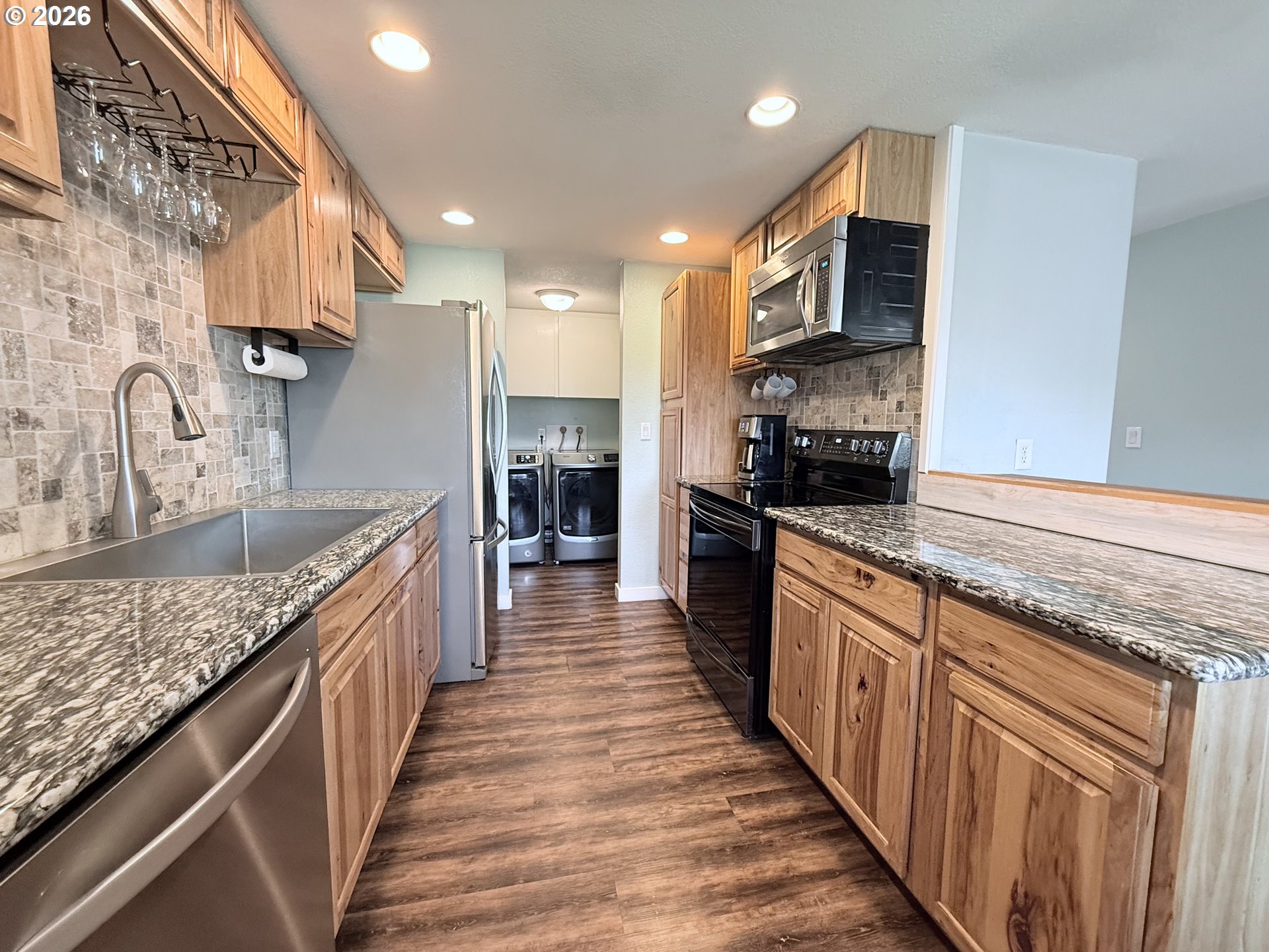 370 North Wall Street Coos Bay, OR 97420 - Photo 14 of 36 a large kitchen with stainless steel appliances granite countertop a lot of counter space and wooden floor
