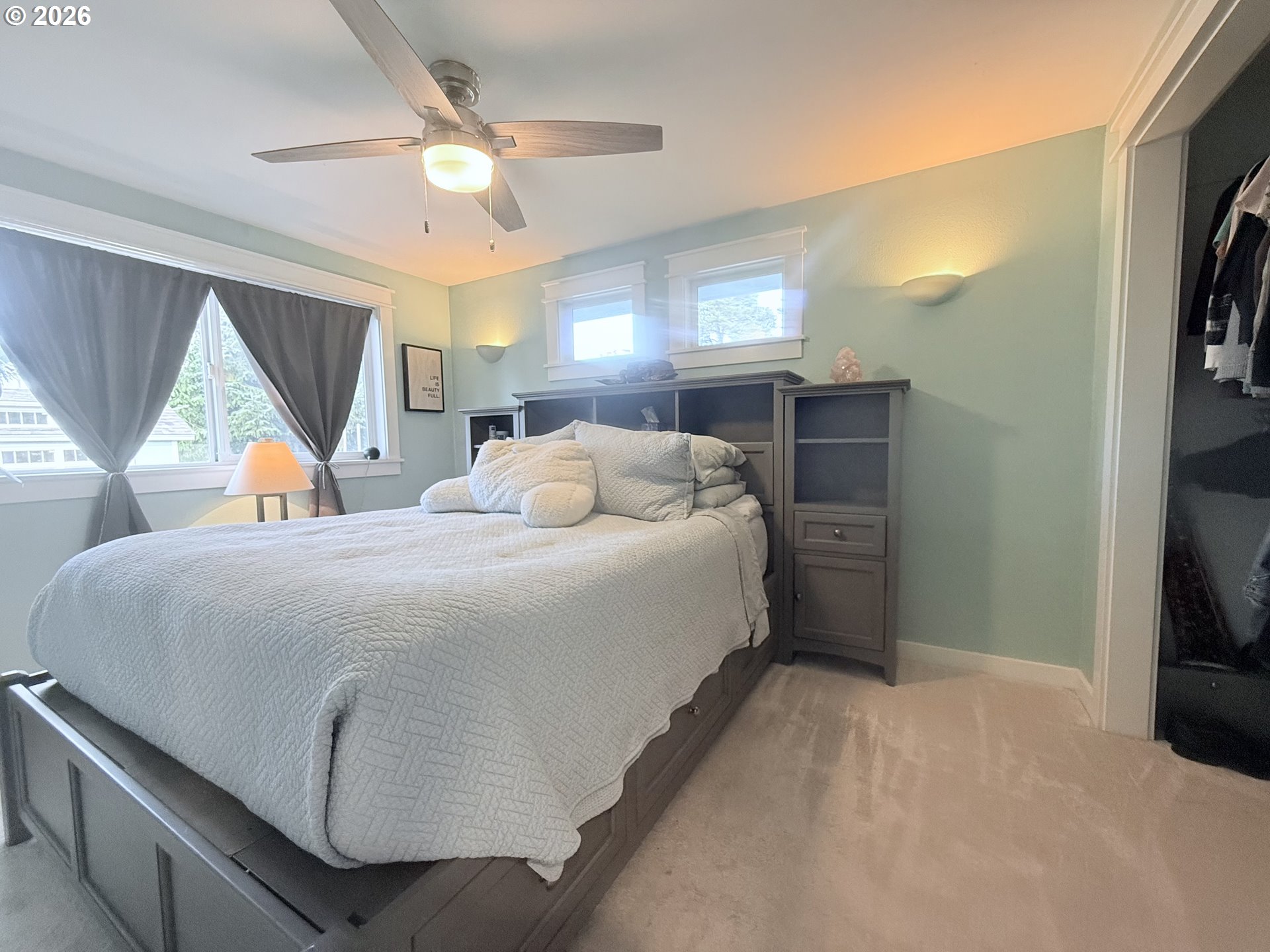 370 North Wall Street Coos Bay, OR 97420 - Photo 18 of 36 a bedroom with a bed and a flat tv screen on the dresser