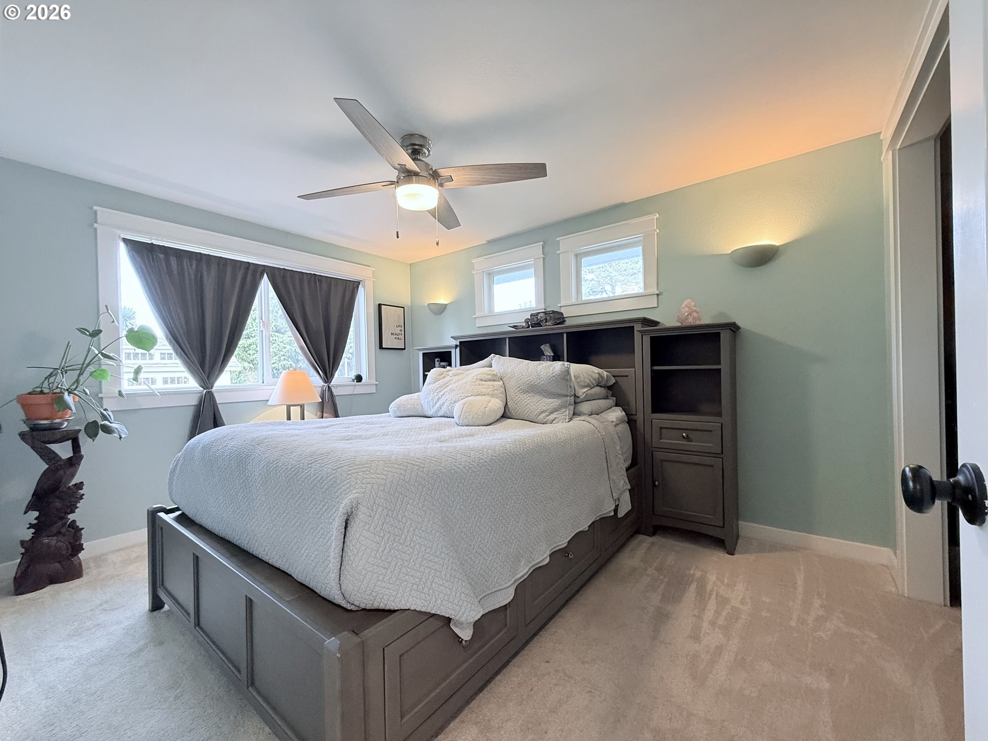 370 North Wall Street Coos Bay, OR 97420 - Photo 20 of 36 a bedroom with a large bed and a chandelier