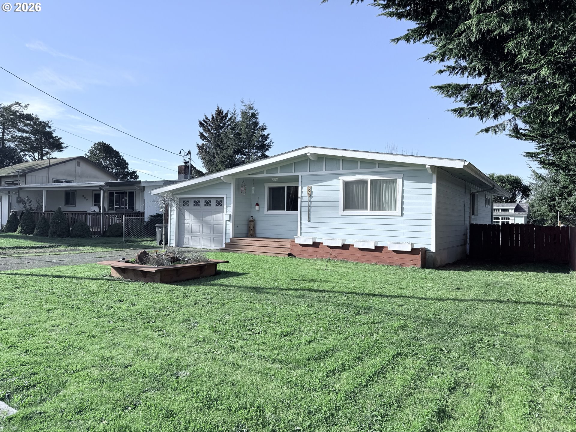 370 North Wall Street Coos Bay, OR 97420 - Photo 2 of 36 a front view of a house with a yard and garage