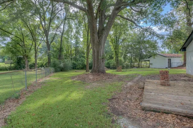 a view of a house with a backyard