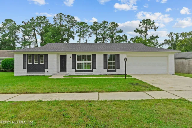 a bathroom with a granite countertop toilet sink and mirror