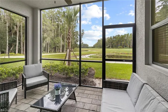 a living room with couch and a floor to ceiling window