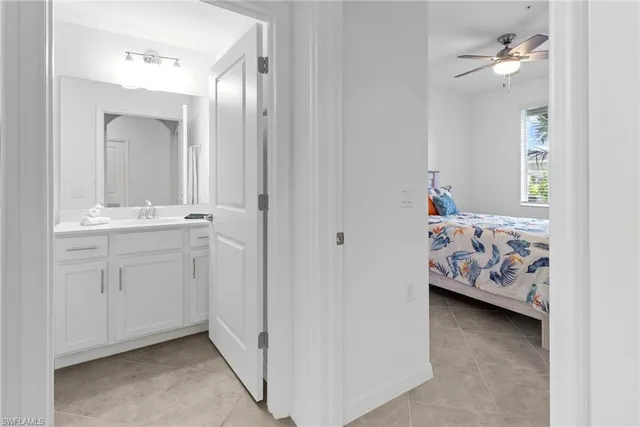 a en suite bathroom with a double vanity sink and a mirror