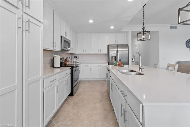a kitchen with kitchen island white cabinets and white appliances