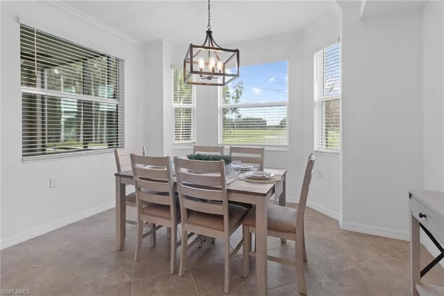 a dining room with furniture a chandelier and wooden floor