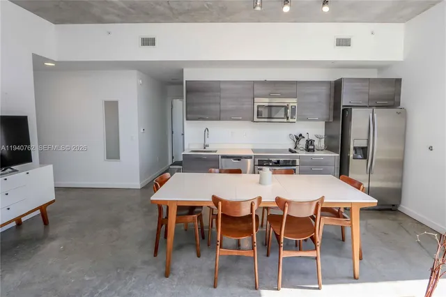 a dinning table and chairs in a kitchen