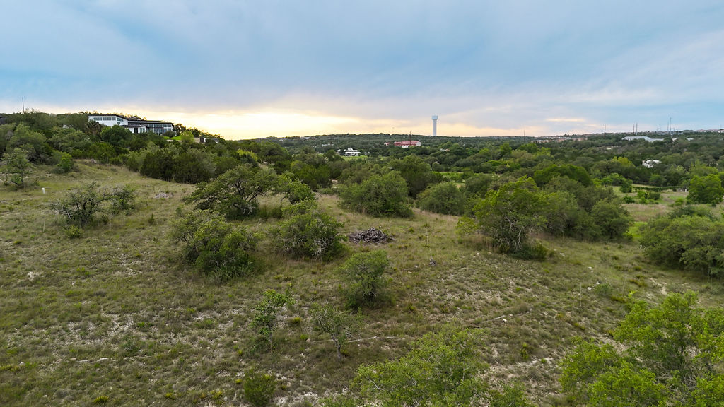 13800 Lone Rider Trail Austin, TX 78738 - Photo 19 of 27 a view of a green field with lots of bushes