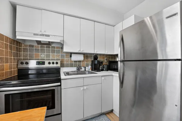 a bedroom with a bed and a dresser in it