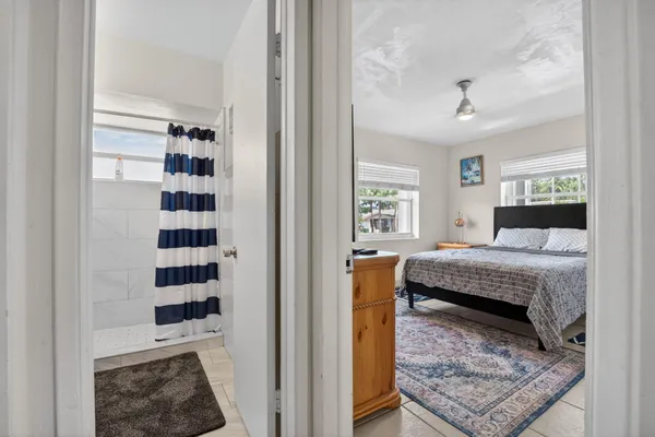 a bedroom with a bed and a painting on the wall