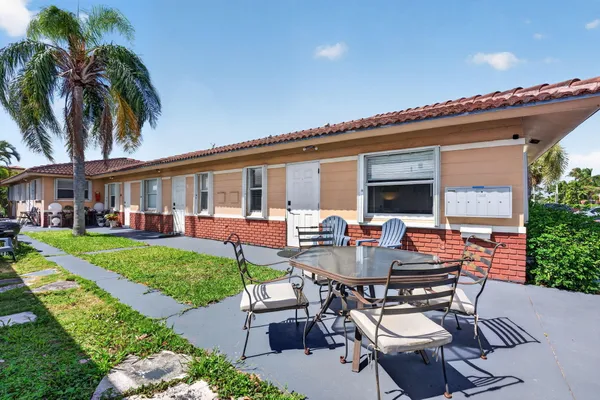 a backyard of a house with outdoor seating