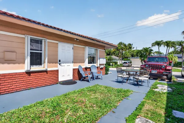 a living room with furniture a ceiling fan a fireplace and a window