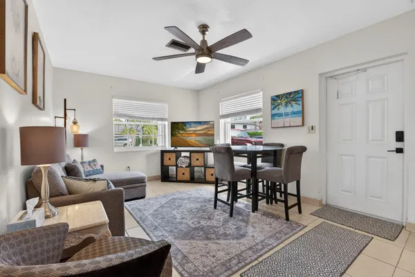 a living room with furniture a fireplace and a flat screen tv
