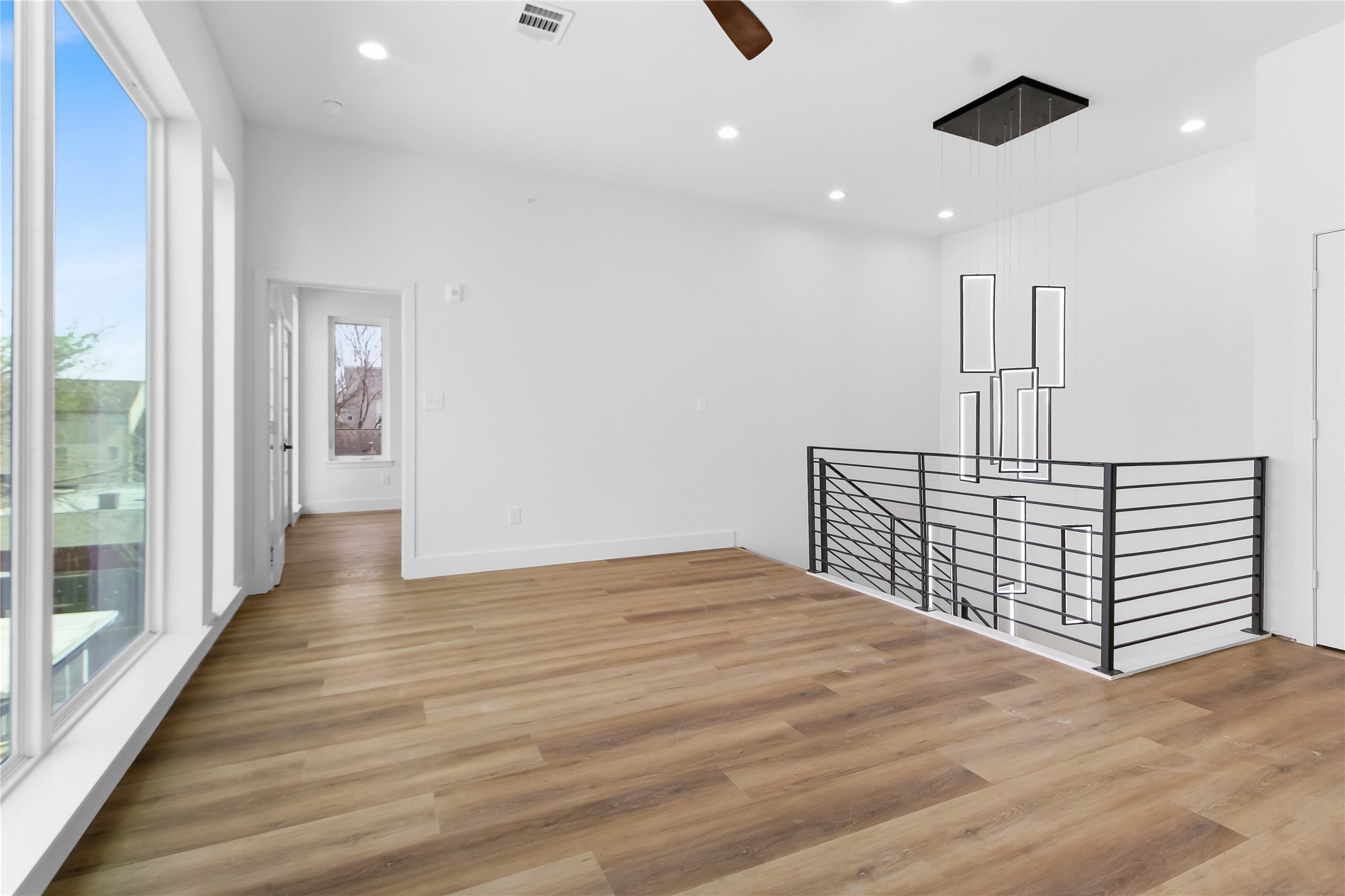 5614 Larkin Street, Unit G Houston, TX 77007 - Photo 15 of 20 a view of a hallway with wooden floor and staircase