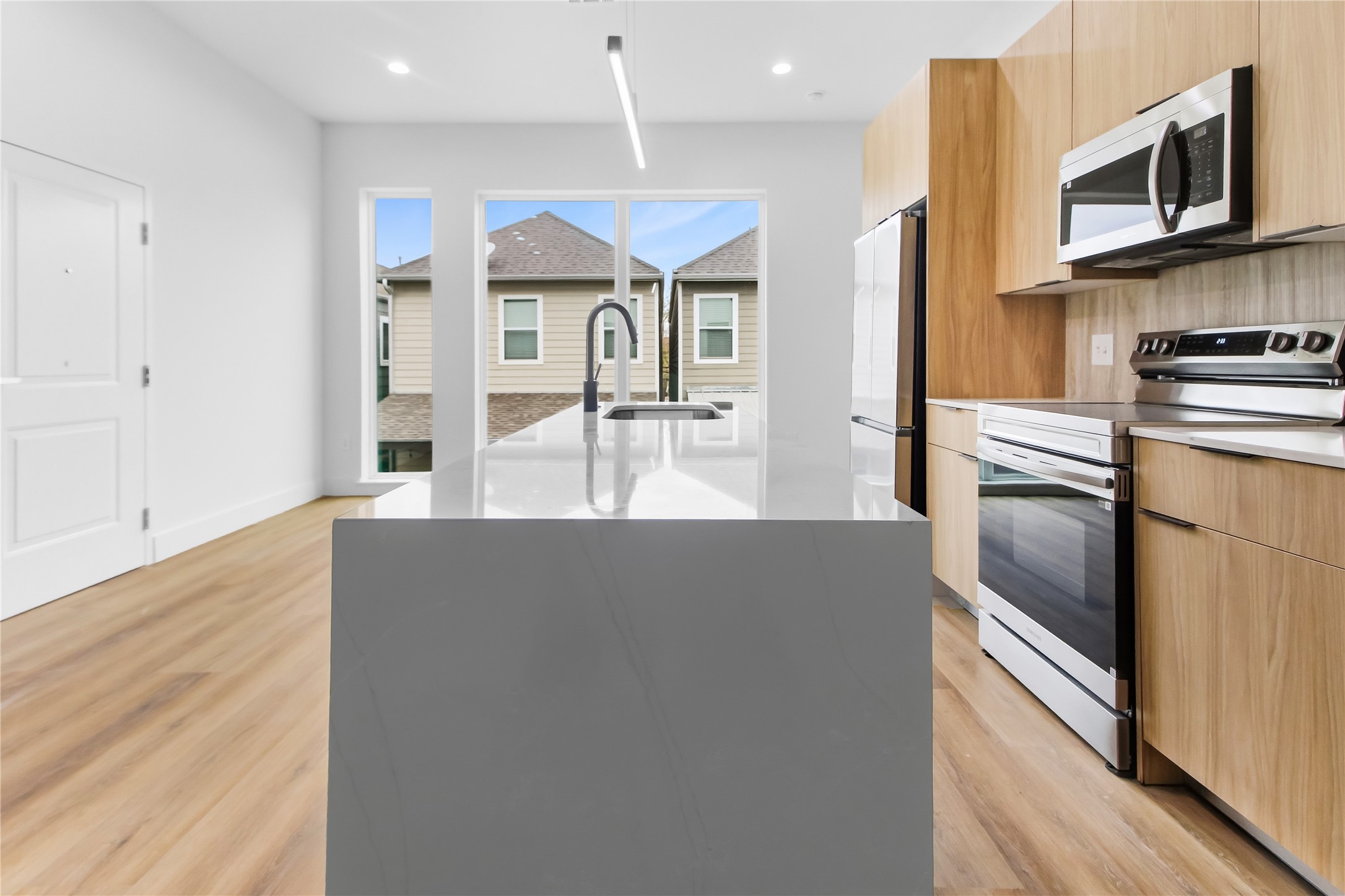 5614 Larkin Street, Unit G Houston, TX 77007 - Photo 3 of 20 a kitchen with stainless steel appliances granite countertop a refrigerator and a stove