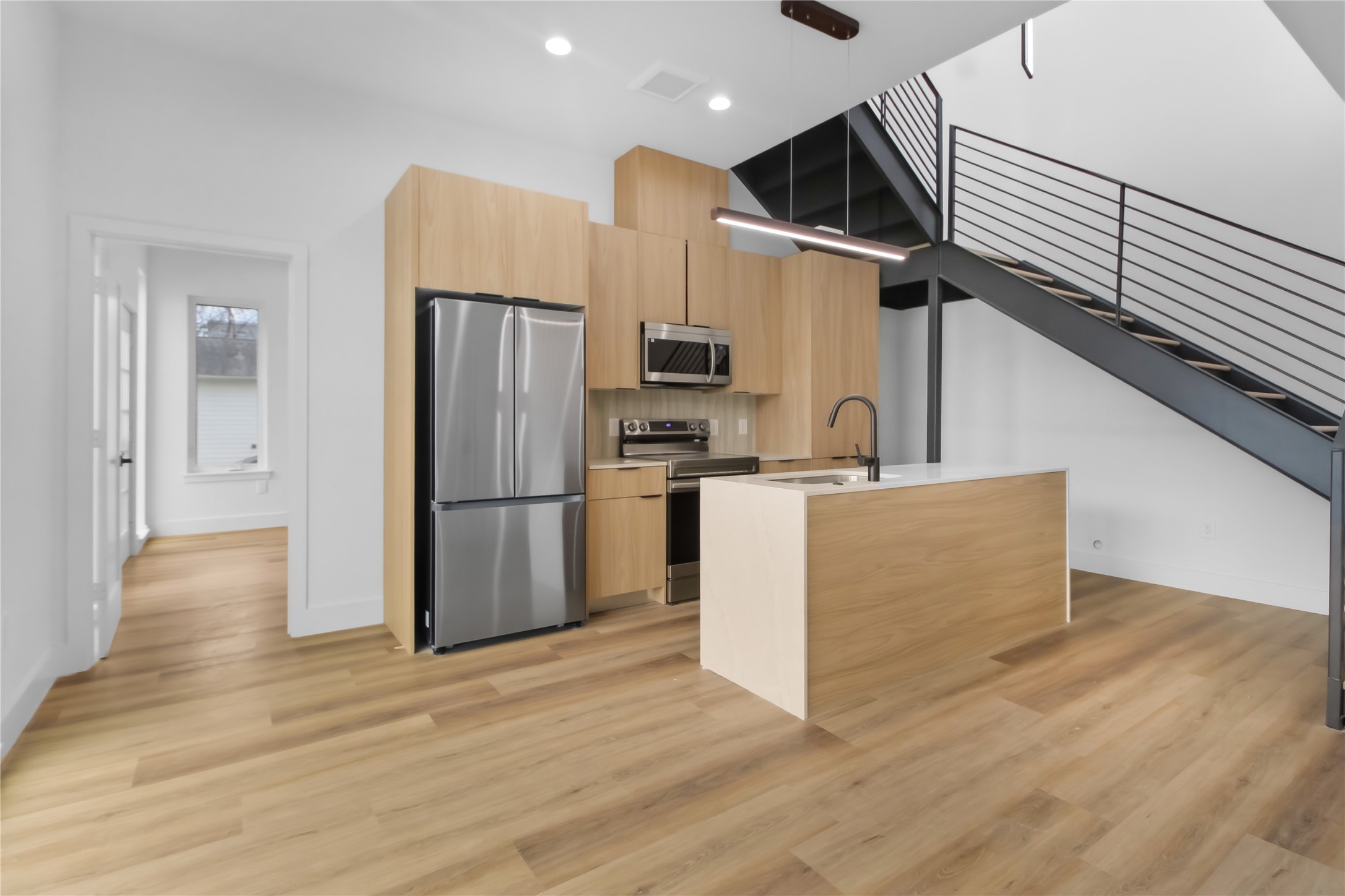 5614 Larkin Street, Unit G Houston, TX 77007 - Photo 4 of 20 a kitchen with kitchen island stainless steel appliances a sink and cabinets