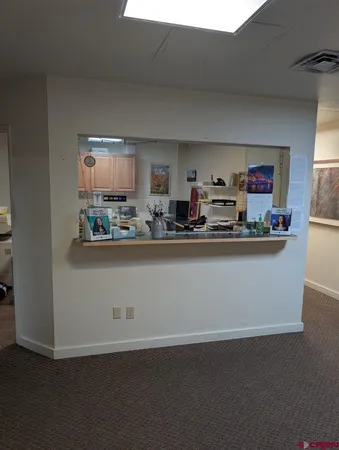 a room with kitchen countertops and wooden floor