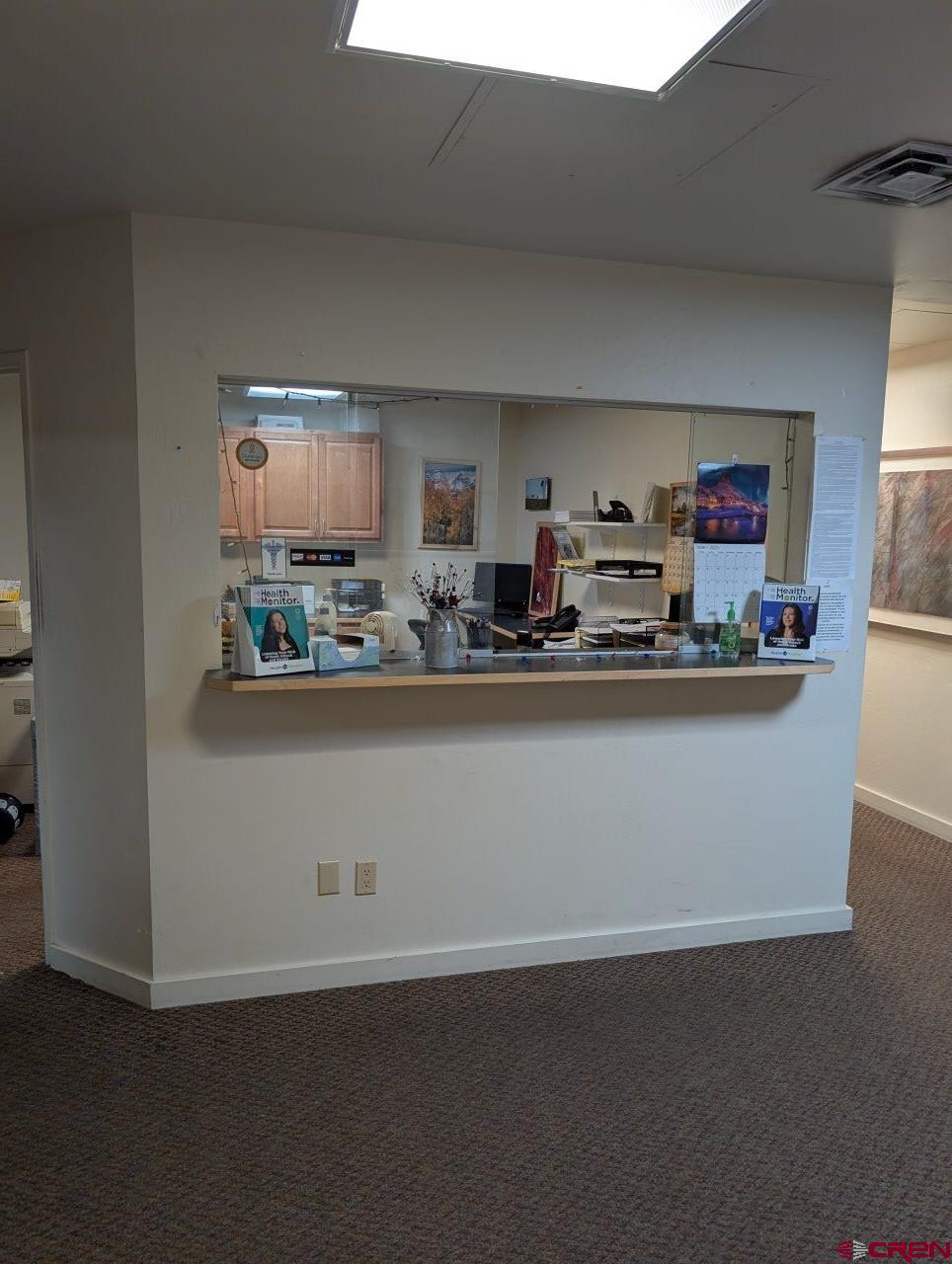 a room with kitchen countertops and wooden floor