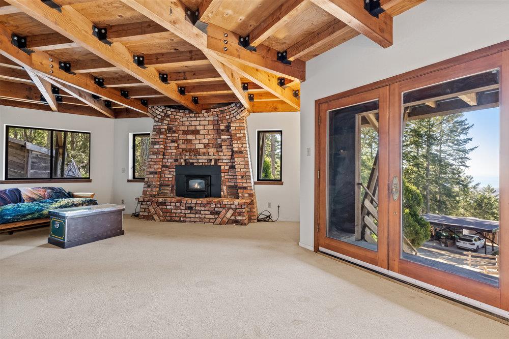 200 South Ranch Road Pescadero, CA 94060 - Photo 27 of 72 a living room with furniture and a fireplace