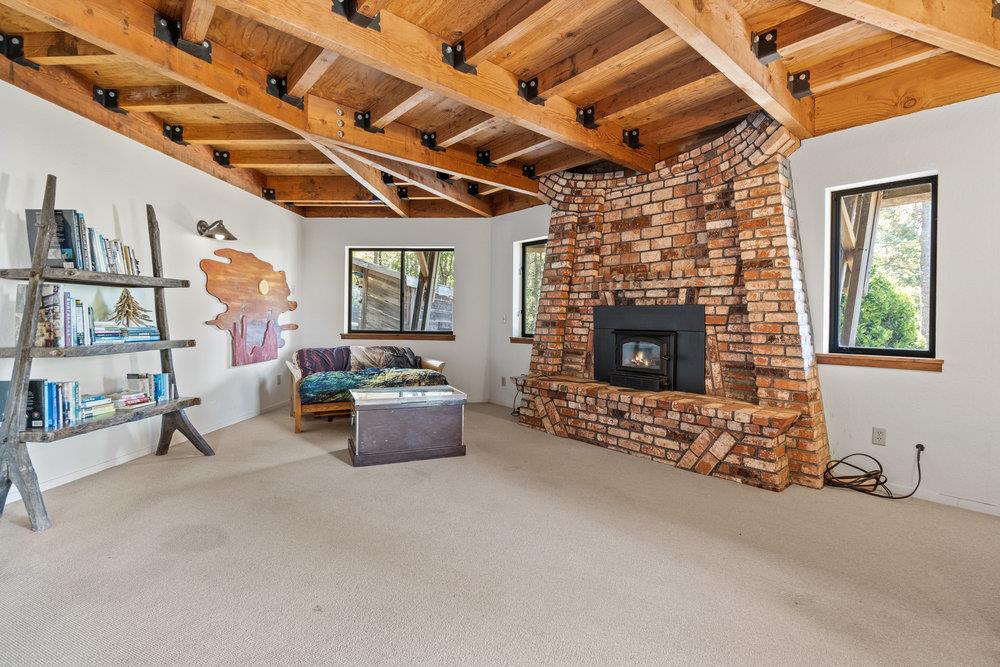 200 South Ranch Road Pescadero, CA 94060 - Photo 28 of 72 a living room with furniture and a fireplace