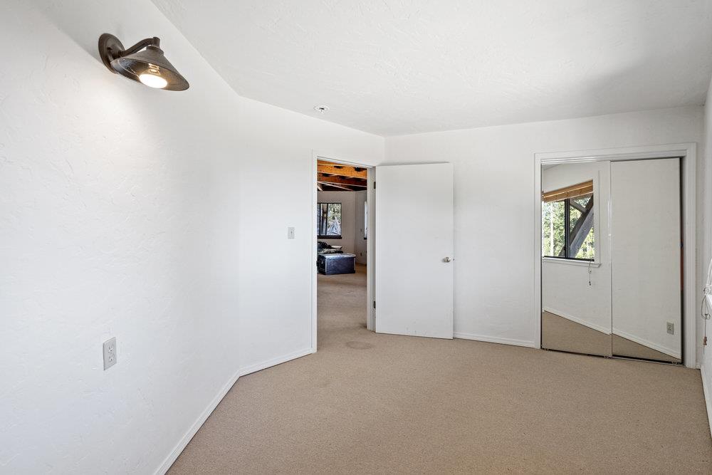 200 South Ranch Road Pescadero, CA 94060 - Photo 34 of 72 an empty room with closet and wooden door