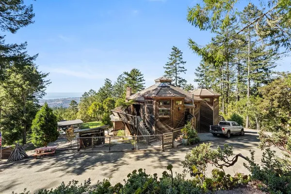 an aerial view of a house with yard and patio