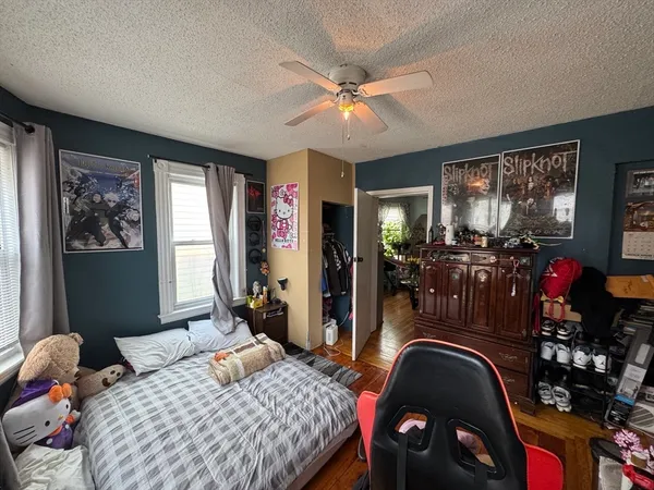 a bedroom with bed and glass window