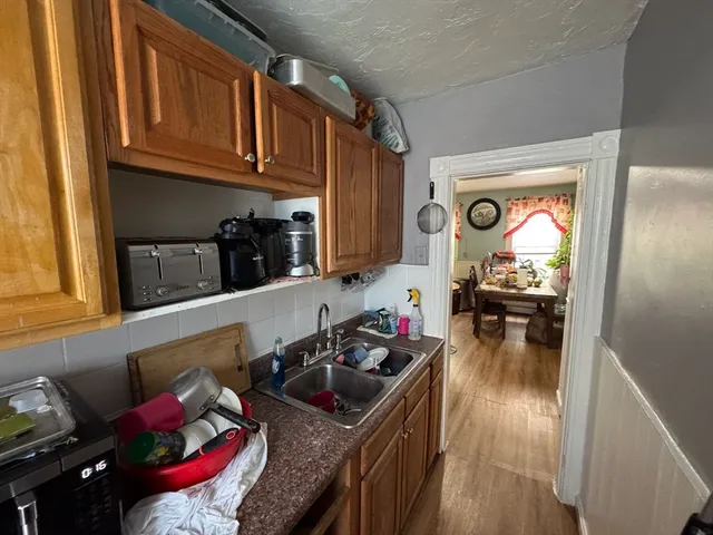 a kitchen with sink refrigerator and cabinets