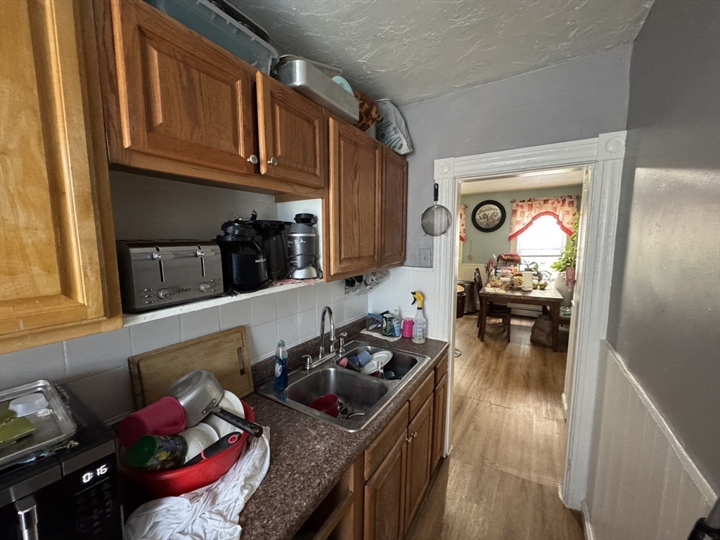 27 Harlow Street Worcester, MA 01605 - Photo 20 of 32 a kitchen with sink refrigerator and cabinets