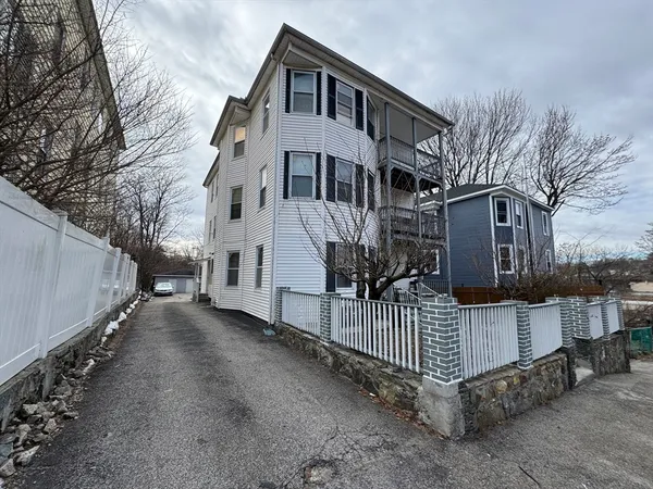 a view of a house with wooden fence