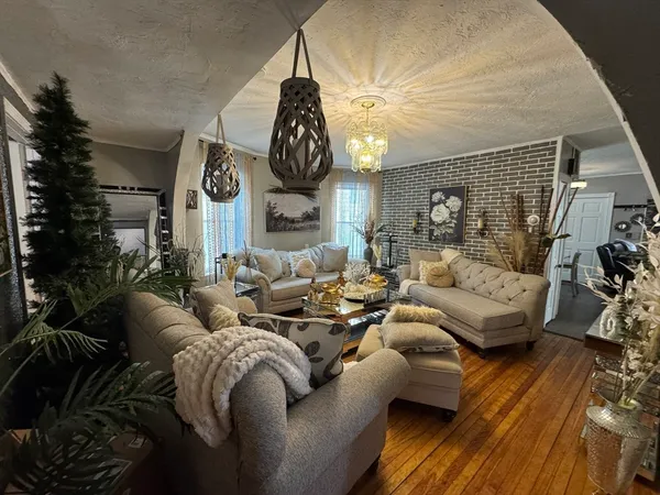 a living room with furniture and wooden floor
