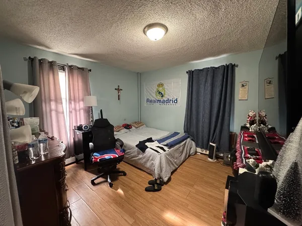 a bedroom with furniture and a window