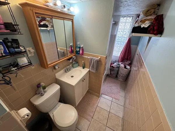 a bathroom with a toilet sink and mirror