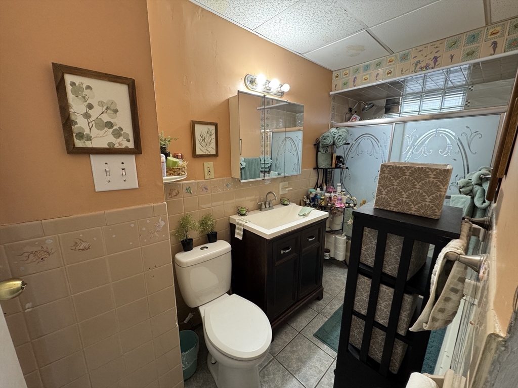 27 Harlow Street Worcester, MA 01605 - Photo 26 of 32 a bathroom with a toilet a sink and mirror