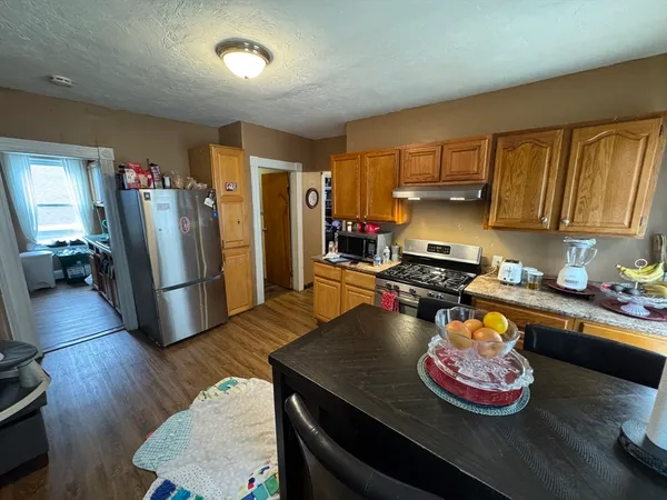 a kitchen with stainless steel appliances granite countertop a stove refrigerator and microwave
