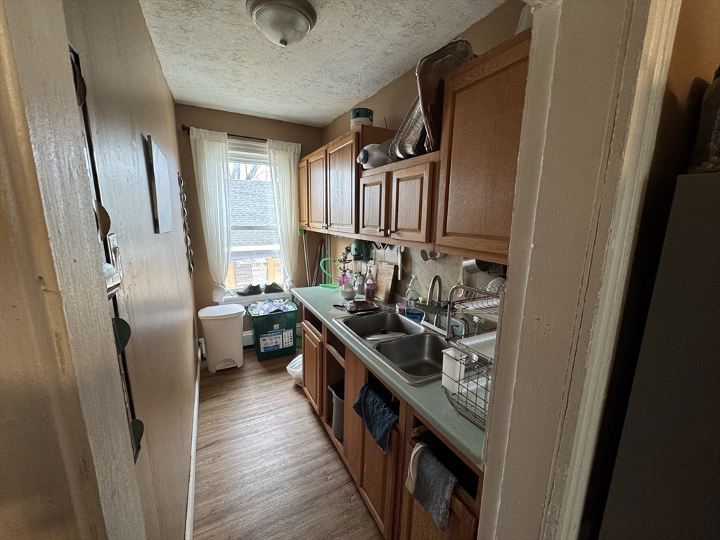 27 Harlow Street Worcester, MA 01605 - Photo 6 of 32 a kitchen with sink a stove and refrigerator