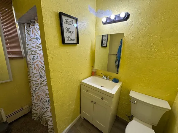 a bathroom with a sink mirror vanity and toilet