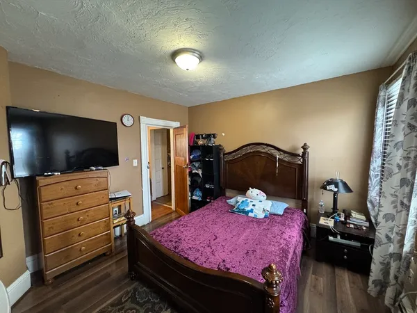 a bedroom with a bed and a flat screen tv