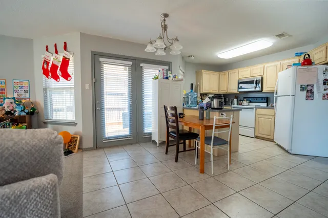 a view of a dining room with furniture and chandelier