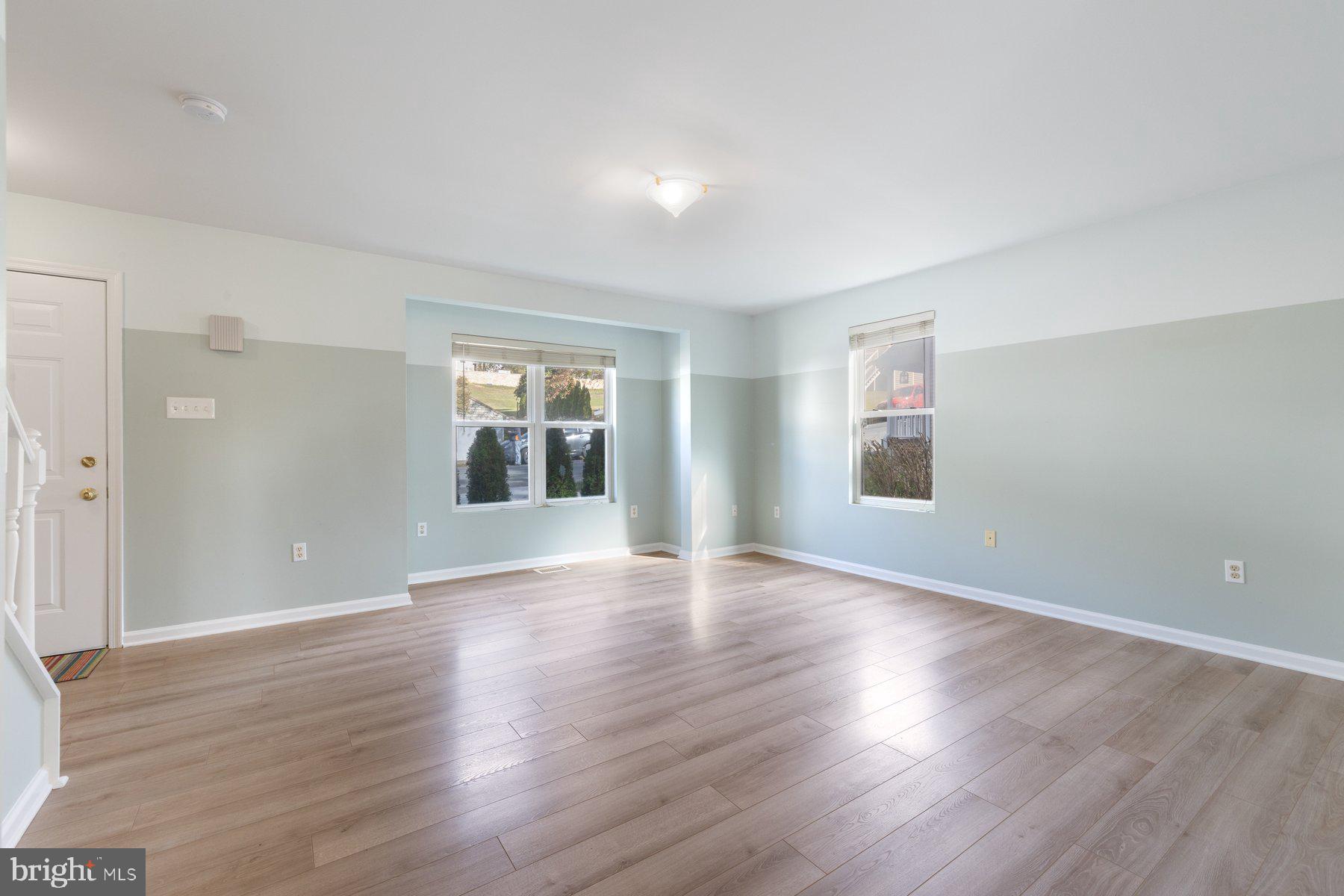 822 East B Street Brunswick, MD 21716 - Photo 18 of 42 an empty room with wooden floor and windows