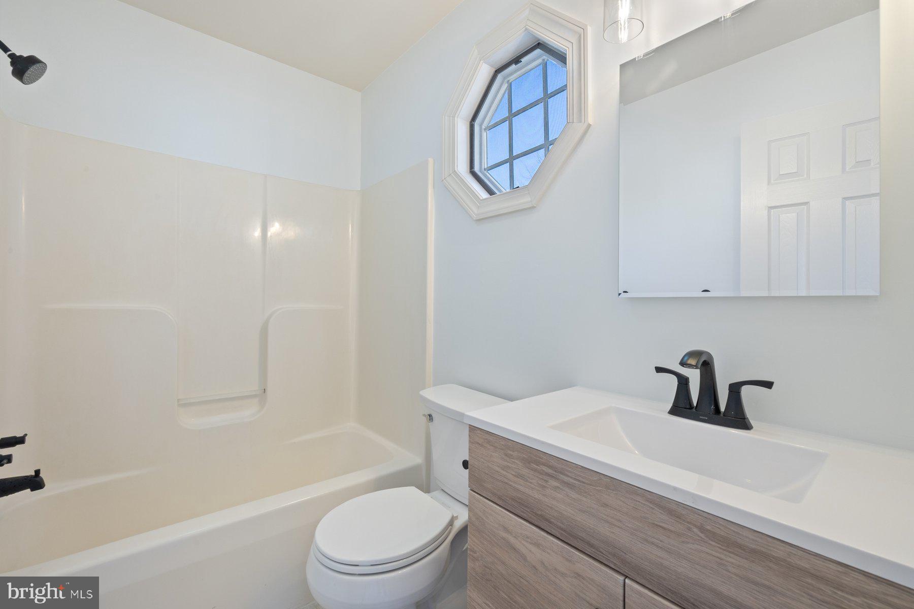 822 East B Street Brunswick, MD 21716 - Photo 29 of 42 a bathroom with a sink a toilet and shower