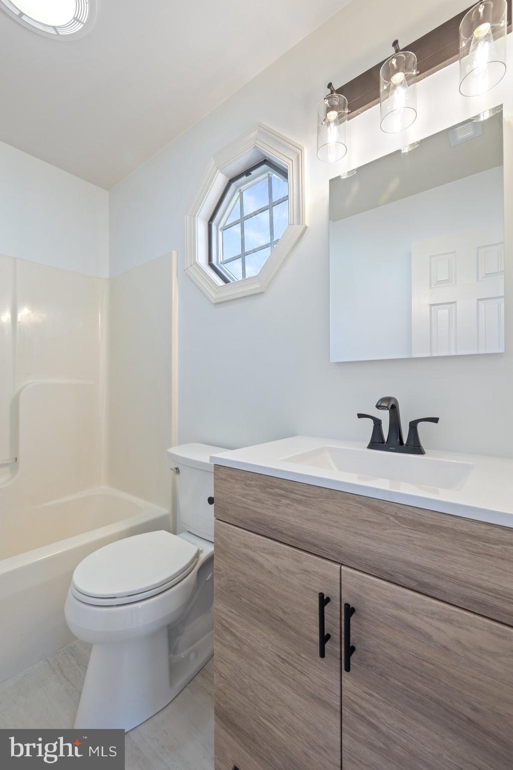 822 East B Street Brunswick, MD 21716 - Photo 30 of 42 a bathroom with a toilet a sink and mirror