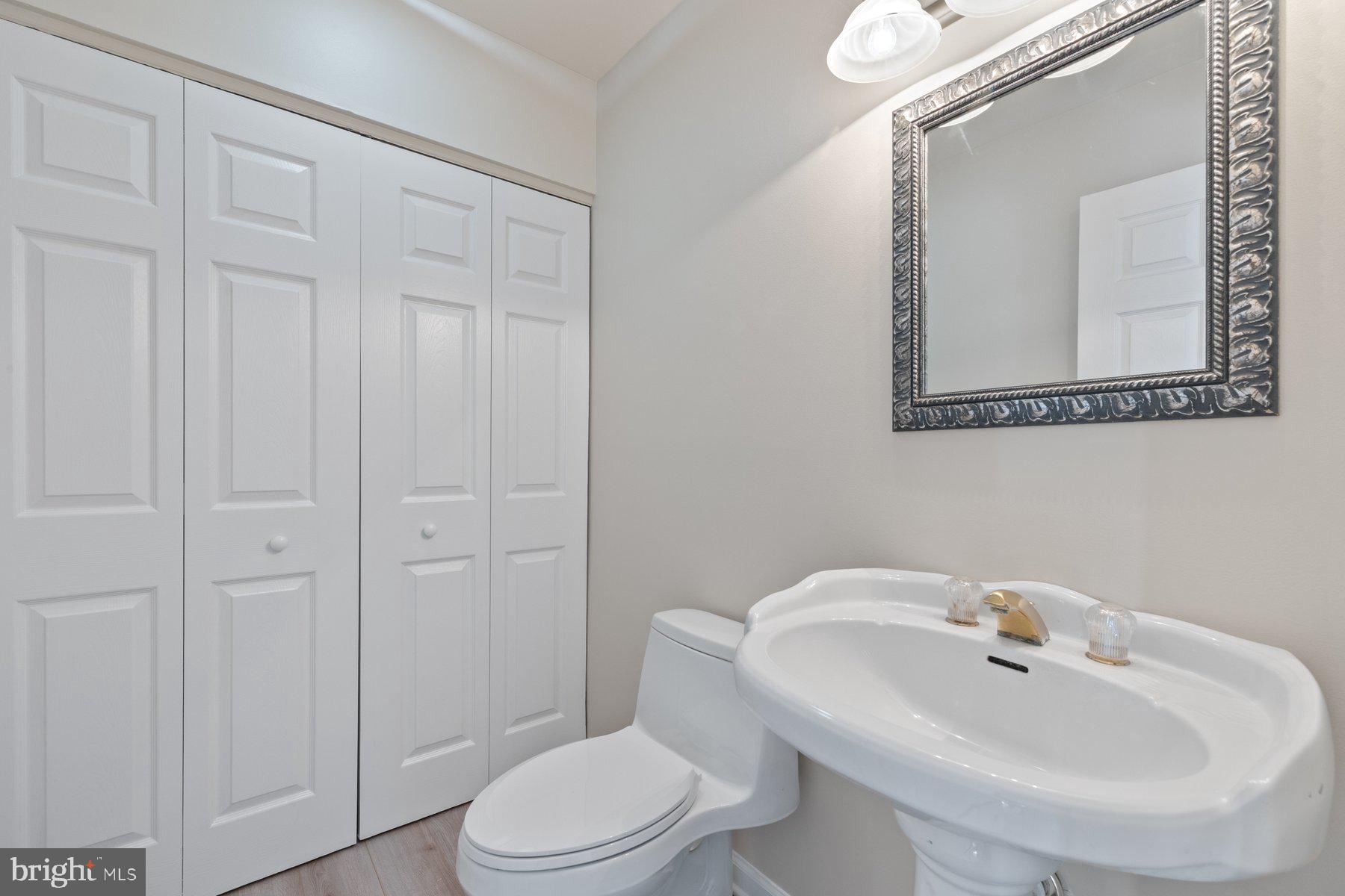 822 East B Street Brunswick, MD 21716 - Photo 31 of 42 a bathroom with a toilet a sink and mirror