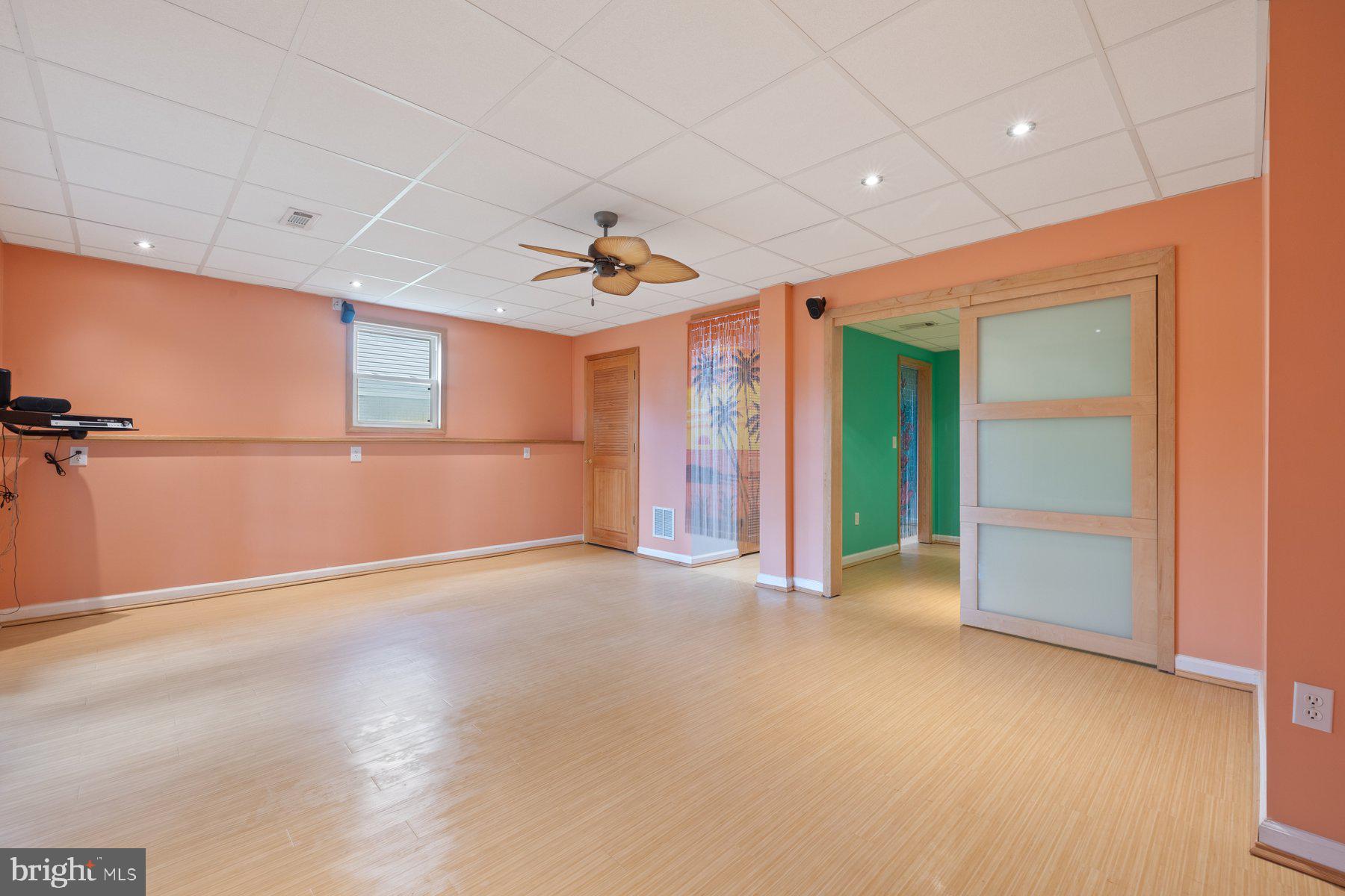 822 East B Street Brunswick, MD 21716 - Photo 35 of 42 an empty room with chandelier fan and windows