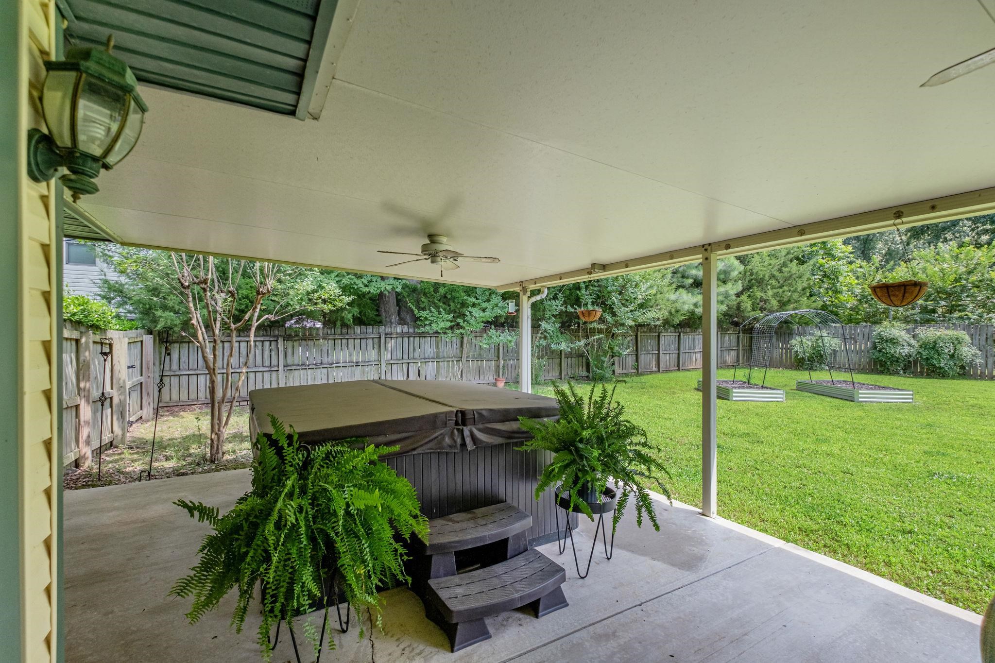 4729 Cedar Ridge Drive Millington, TN 38053 - Photo 34 of 40 Covered patio featuring a ceiling fan, exterior lighting, and a hot tub