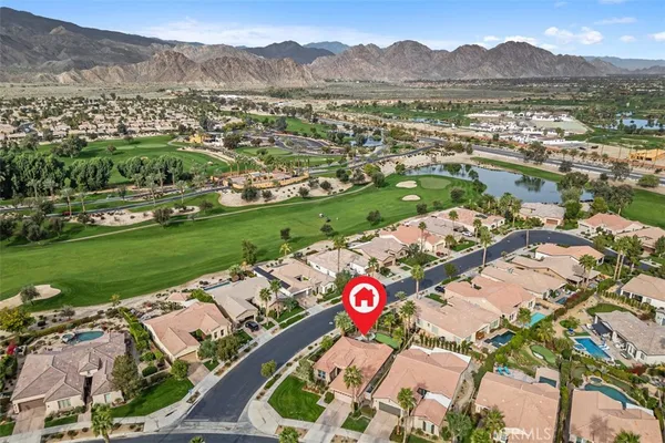 a front view of a house with a garden and trees