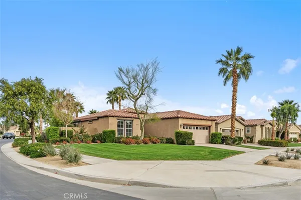 a living room with furniture and a painting on the wall
