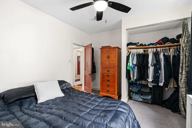 a bedroom with a bed closet and a walk in closet