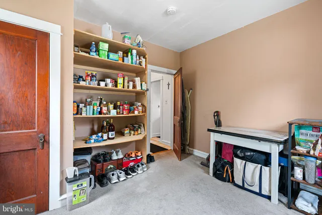 a living room with lots of furniture and a book shelf
