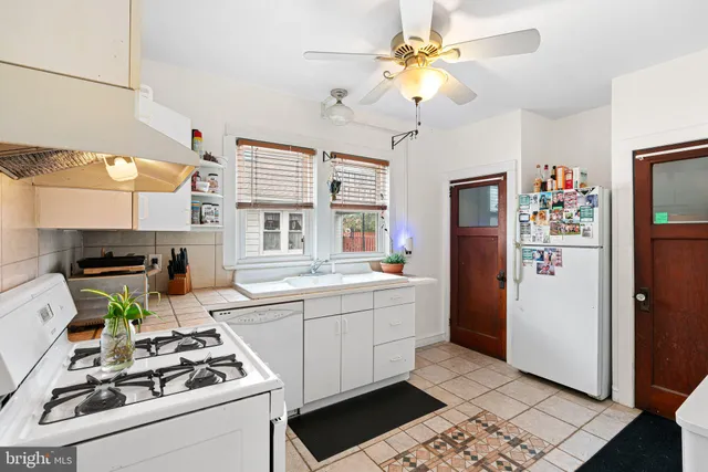 a kitchen with stainless steel appliances a stove a refrigerator and a sink